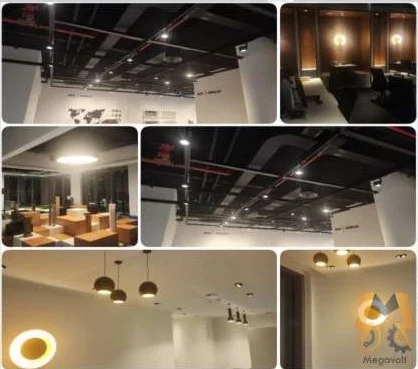 Completed office fit-out at Dubai Hills with exposed black ceiling, track lighting and pendant lights